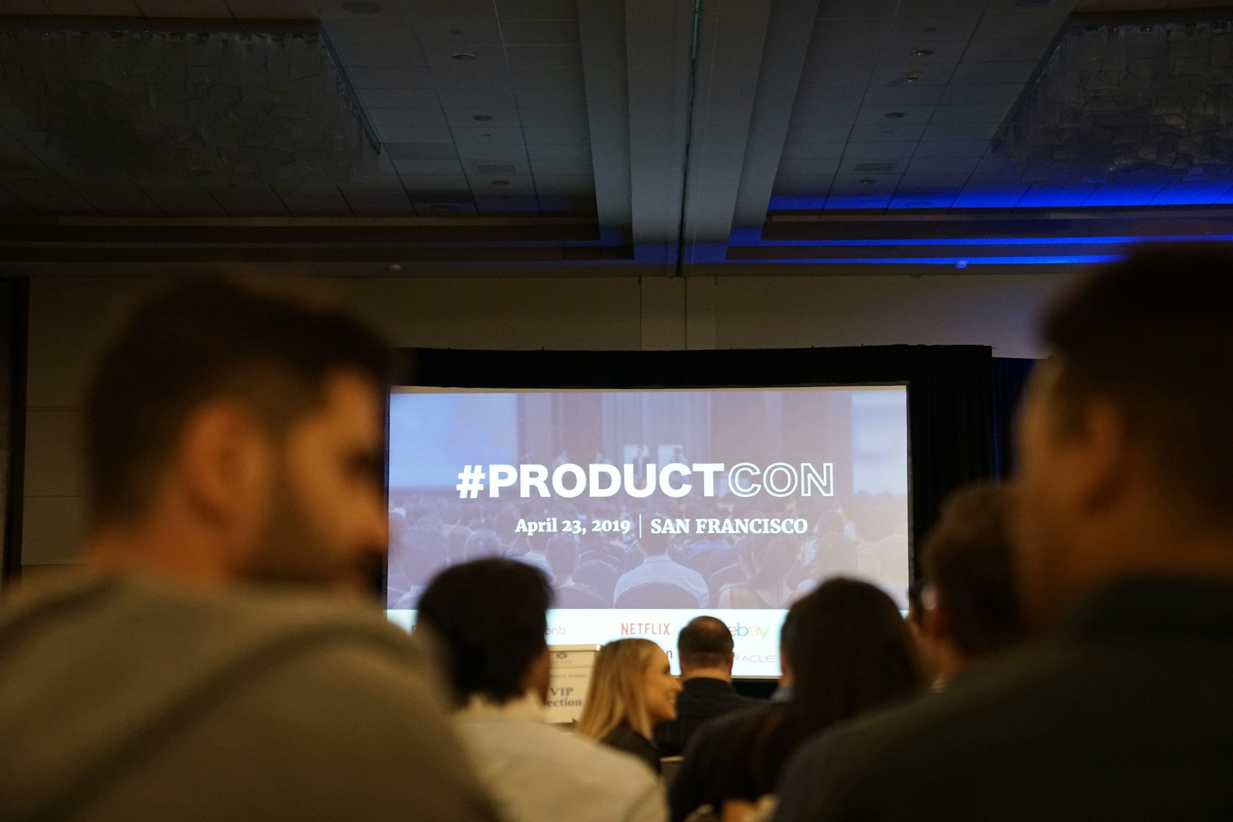 Audience attending a professional conference presentation