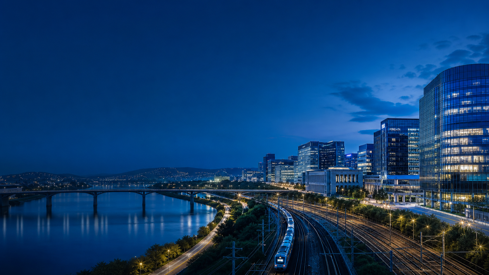 European business district connected by rail, river, and bridges at blue hour