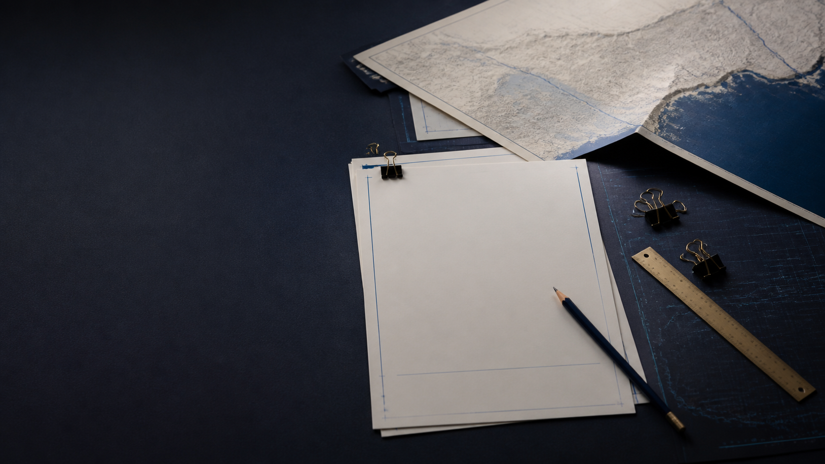 A decision brief, regional map, pencil, and research tools arranged on a dark worktable